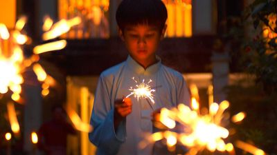 Ramadan. Little boy with sparklers. During the holy month of Ramadan Muslims break their fast each evening with prayer followed by festive nighttime meals called iftars. Islam