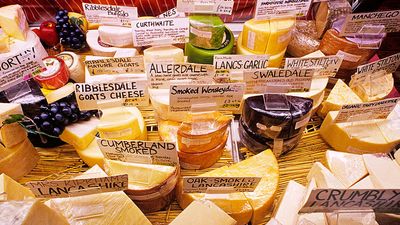 Cheese. Dairy. English cheese. A selection of cheeses on display a the market.