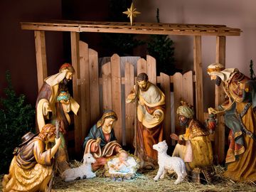 Christmas Manger scene with figurines including Jesus, Mary, Joseph, sheep and magi. Nativity scene, birth, Bethlehem, Christianity.