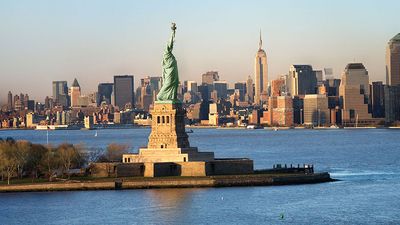 Statue of Liberty in front of the skyline of Manhattan, New York City, New York.